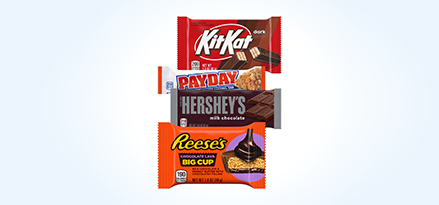 Kit Kat® Dark bar, Payday® bar, Hershey’s® bar and Reese’s® Dark Lava cups stacked on top of each other.