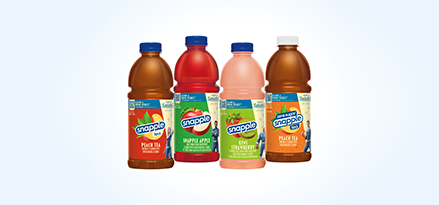 Snapple Peach Tea, Snapple Apple, Kiwi Strawberry, and Zero Sugar Peach Tea bottles in a row.